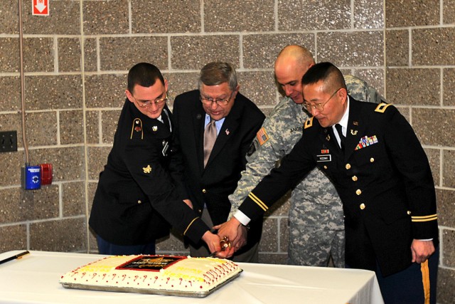 Oldest and youngest with Army Reserve ambassador cut Fort McCoy's cake