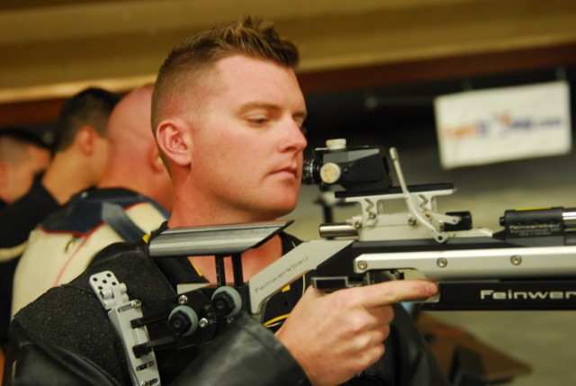 Staff Sgt. Nathan Robbins Inspects His Rifle