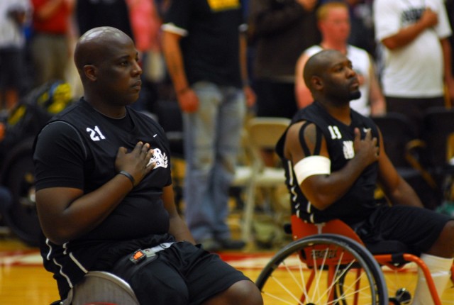 Army Veterans observe the playing of the National Anthem at the Warrior Games