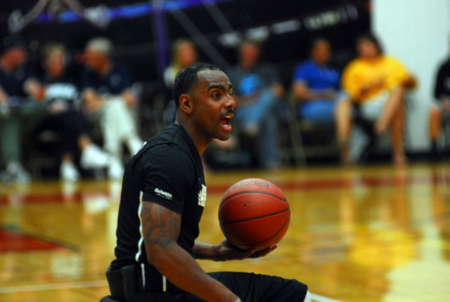 Sgt. Delvin Maston communicates with his team during the first match of the Warrior Games' wheelchair basketball event
