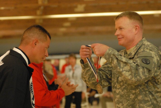 Brig. Gen. David J. Bishop awards Warrior Games bronze medal to Chief Warrant Officer Alan Hart
