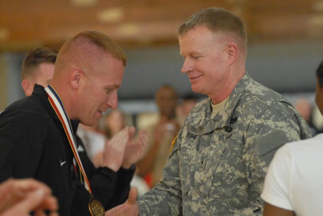Staff Sgt. David Carte is awarded his gold medal by Brig. Gen. David J. Bishop