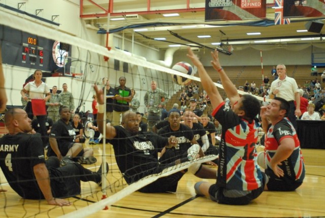 Maj. Thomas Davis hits the ball during Warrior Games sitting volleyball match