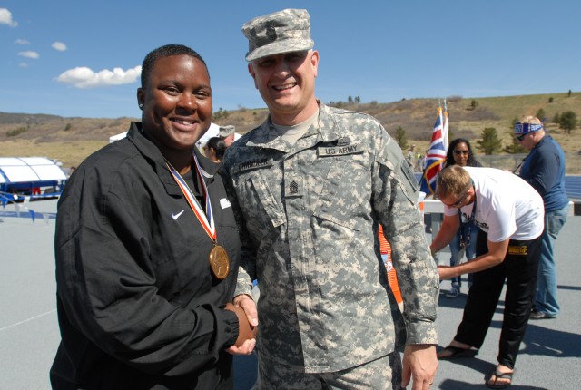 Sgt. Mag. of the Army presents Warrior Games gold medalist Sgt. Monica Southall a coin