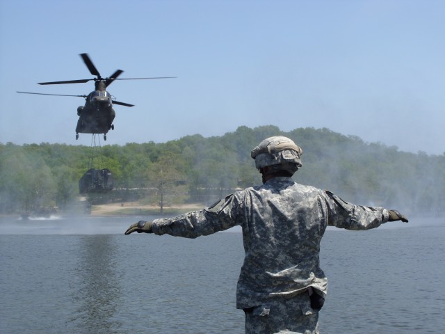 Soldier signals to load-bearing helicopter