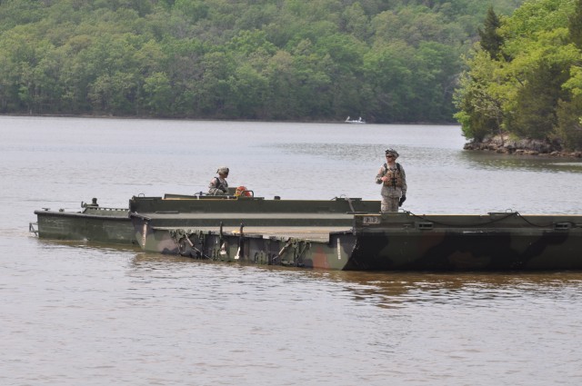 Bridging Soldiers maneuver interior bay toward hasty raft construction site