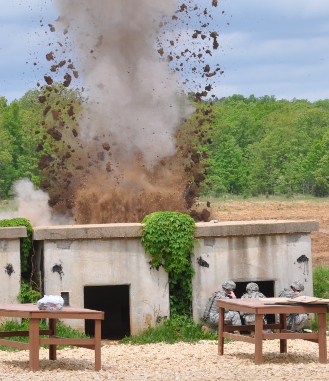 Soldiers take cover during cratering charge detonation