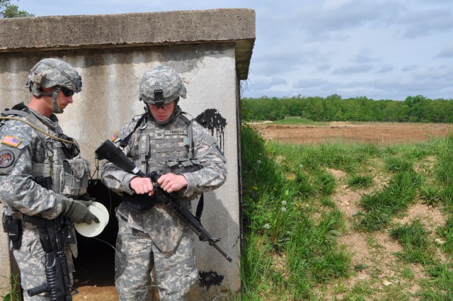 Soldier prepares detonator for cratering charge