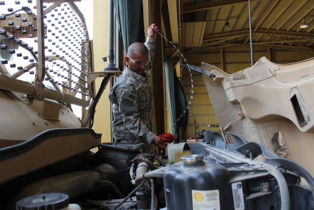 4-401st AFSB Quality Assurance Specialist checks MRAP fluid levels