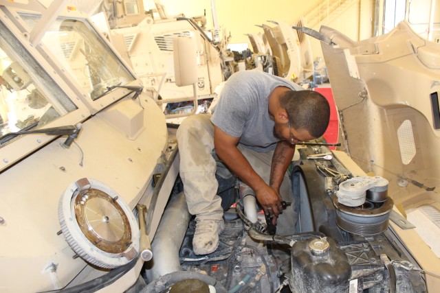 Mechanic conducts maintenance on a MaxxPro Dash Vehicle