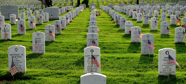 Old Guard Soldiers places flags at Arlington Cemetery