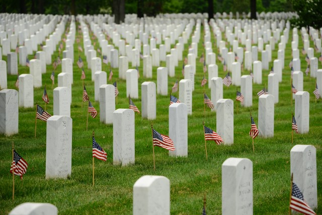 Old Guard Soldiers honor fallen with flags at Arlington graves