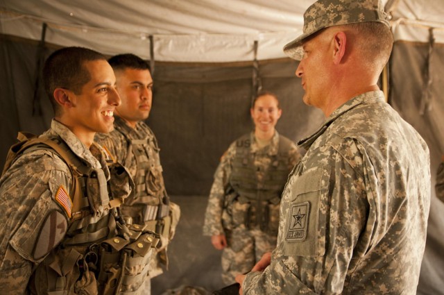 Sergeant major of the Army gives coins of excellence to EFMB recipients