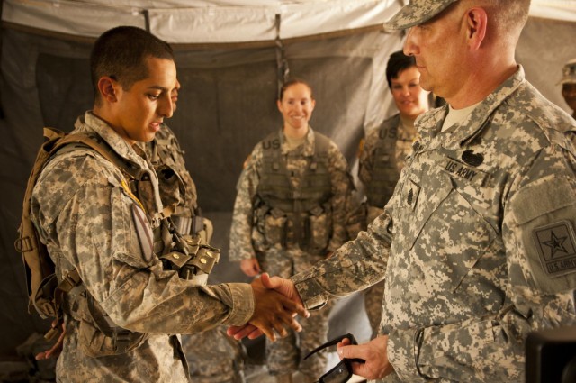 Sergeant major of the Army gives coins of excellence to Expert Field Medical Badge recipients