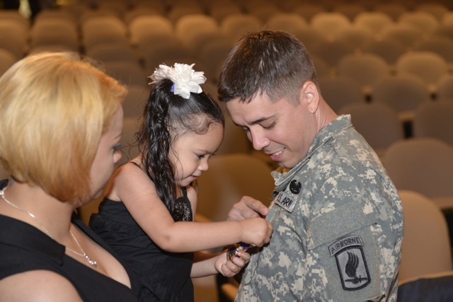 Wounded Soldiers daughter admires Purple Heart