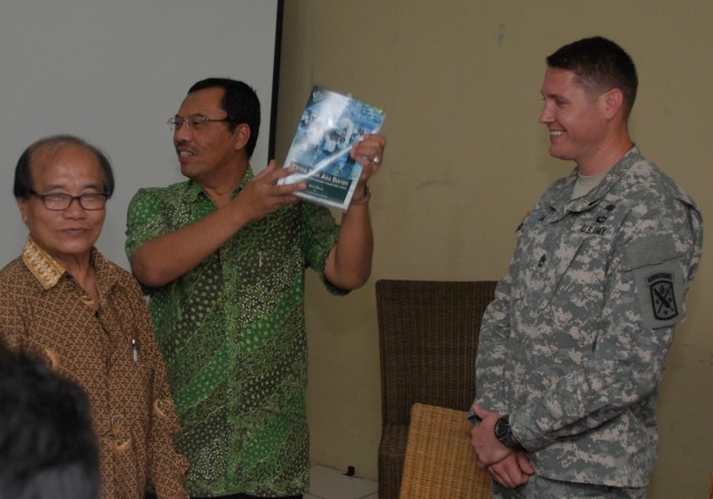 Dr. Mulyaman Soepardi holds up donated medical book