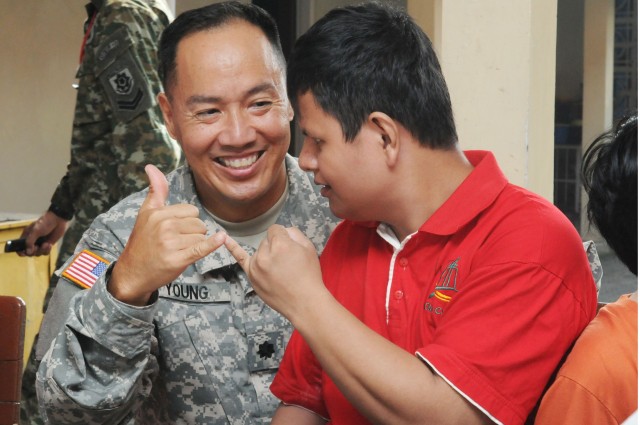 Lt. Col. Mark B. Young teaches how to do a shaka