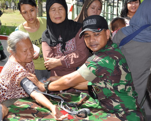 Tentara Nasional Indonesia medic takes vital signs
