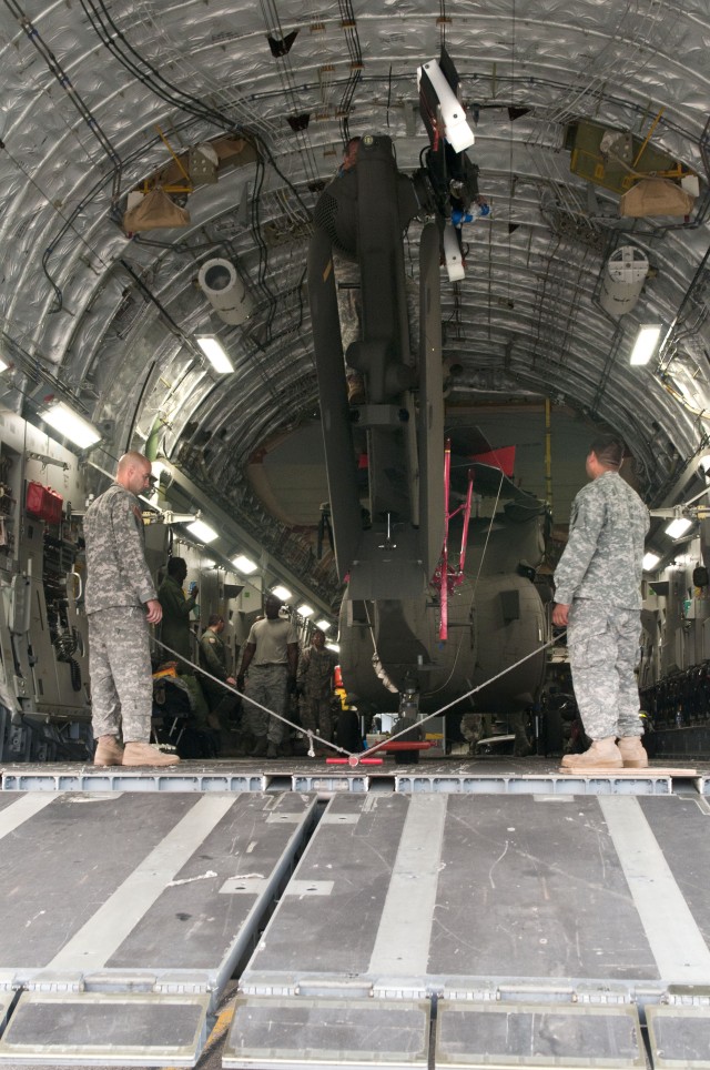 Hawaii Army National Guard, prepare to unload the UH-60 Blackhawk from the C-17 Globemaster III