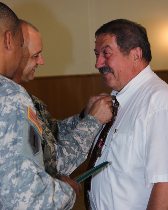 Mr. Leykauf recieves his retirement pin from Col. Lawler