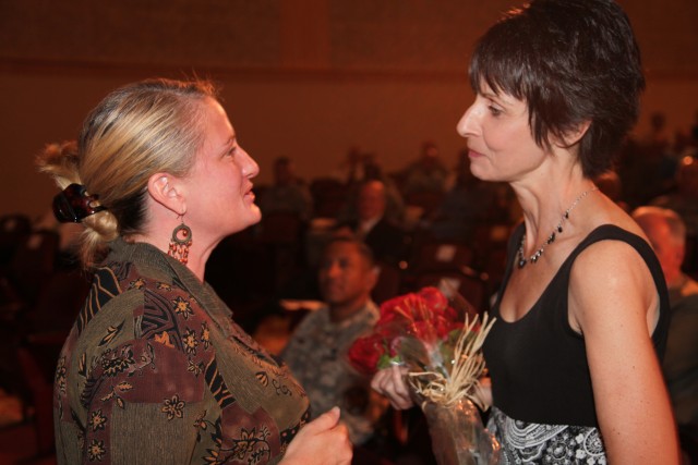 Mrs. Uberti receives flowers from IMCOM staff in appreciation for her support of Soldiers and their Families