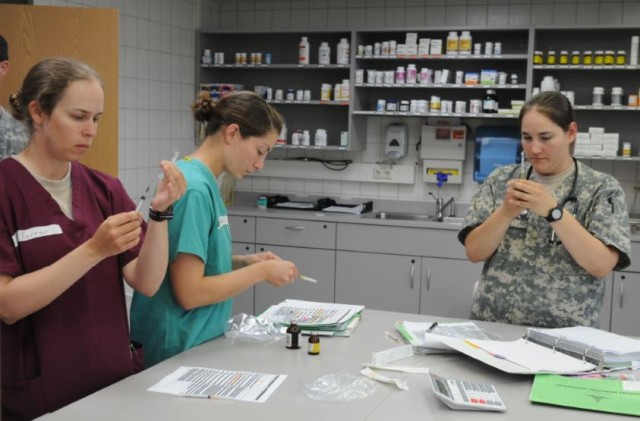 Army veterinarians getting their medicine ready