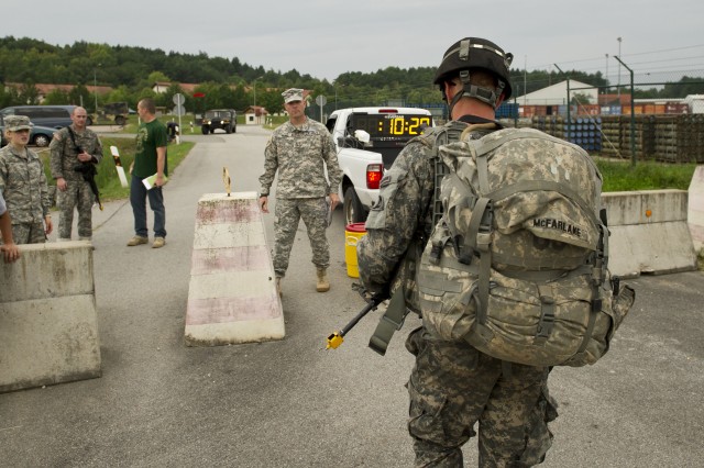 1st. Lt. Stuart McFarlane crosses the finishline for the 12-mile ruck march during EIB