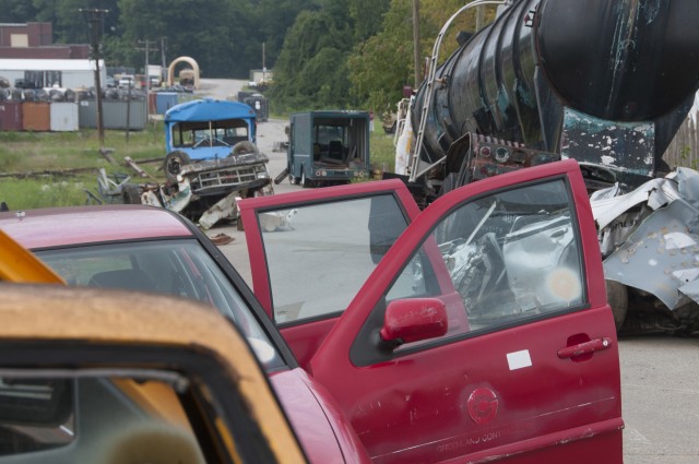 Damaged and abandoned vehicles litter the streets