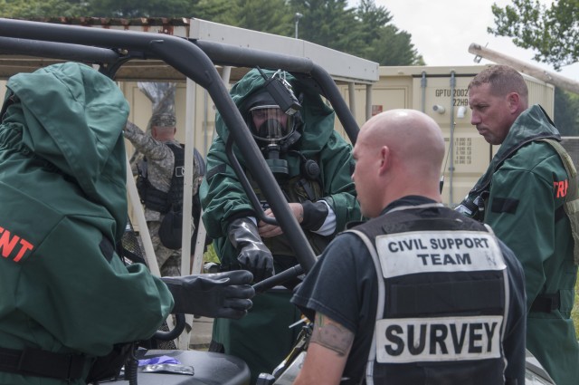 Michigan National Guardsmen don protective suits for reconnaissance mission
