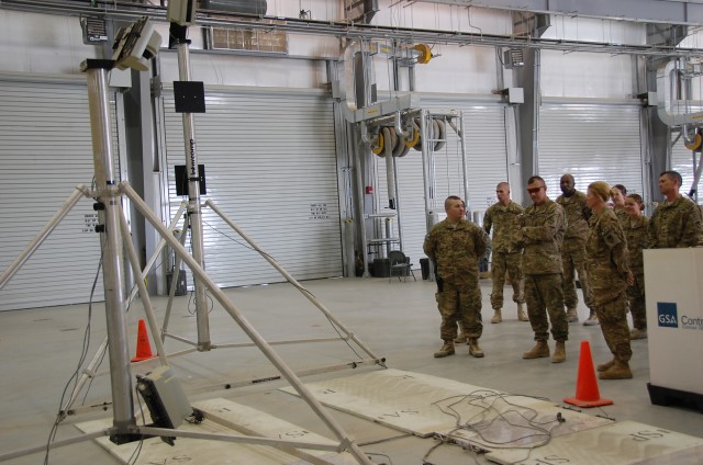 Spc. Newnan briefs 4th ID Deputy Commanding General-Support about weigh-in-motion system