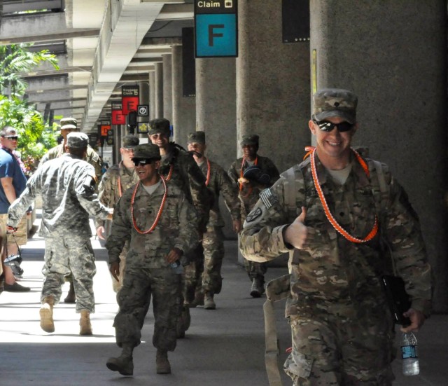 Smiling Alpha Company, 307th Expeditionary Signal Battalion Soldiers exit Honolulu Iternational Airport, after returning from Afghanistan mission.