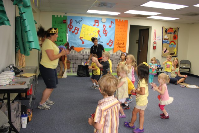 VBS volunteers lead students through dance and song singing routine