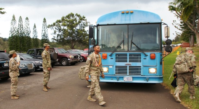 1st Lt. Rashia King and Staff Sgt. Jonathan Diaz welcome Soldiers off bus