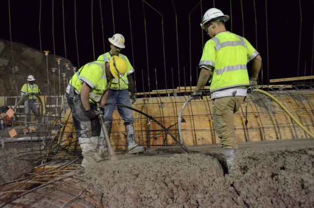 Workers settle concrete atop the Folsom Dam auxiliary spillway's new control structure