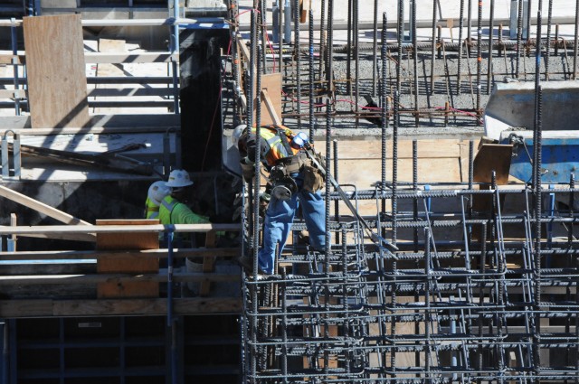 An ironworker ties rebar cages for the Folsom Dam auxiliary spillway control structure