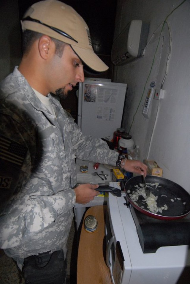 Special Forces interpreter cooks on a hot plate