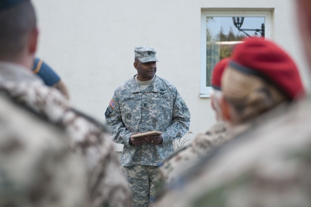 Command Sgt. Maj. David Benning receives a plaque from his German partners