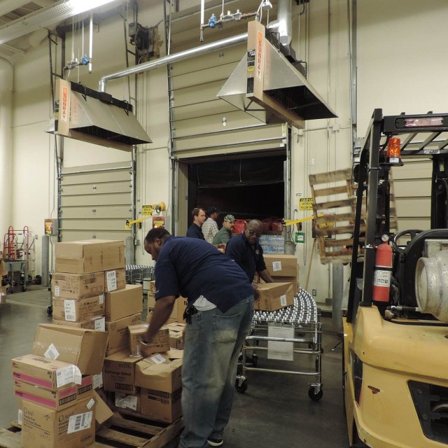 Keelser Exchange associates unload a trailer of emergency supplies in preparation for Tropical Storm Karen.