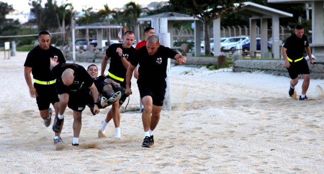 Headquarters and Headquarters Company, 10th Regional Support Group soldiers enjoy a competitive day at the beach