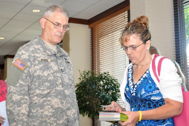 Yellow Ribbon attendee talks to chaplain assistant