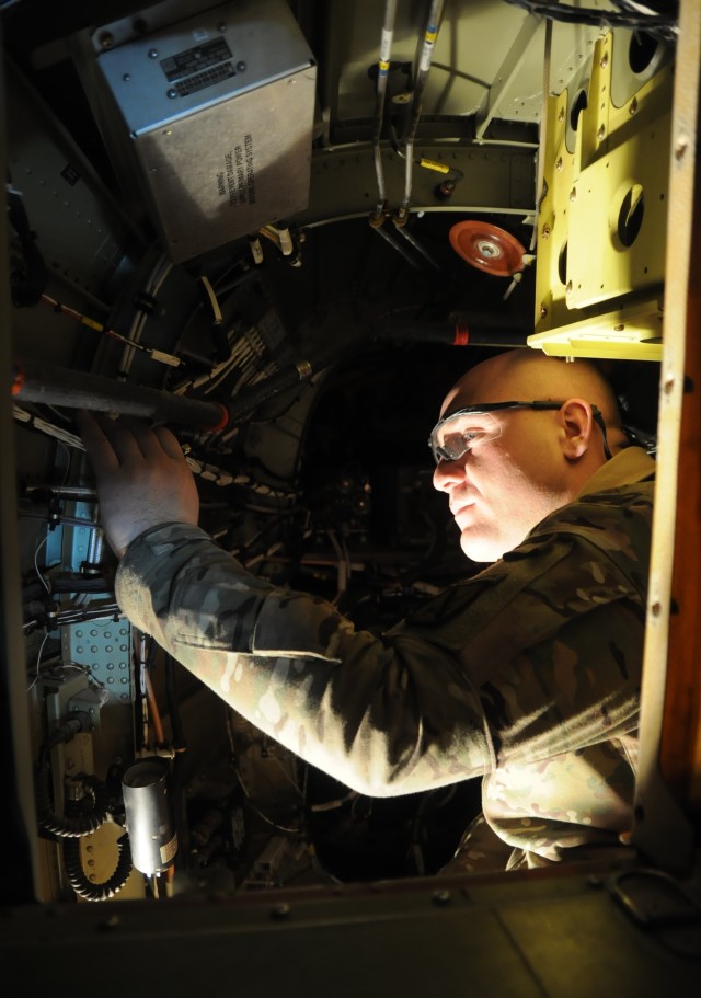 Specialized aviation maintainers repair damaged helicopter's electrical system in painstaking project
