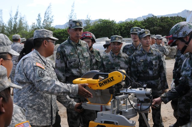 US Soldier demonstrates equipment to People's Liberation Army Soldiers