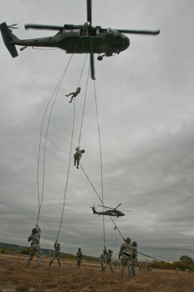 Air assault students rappel 85 feet out of UH-60 Black Hawks