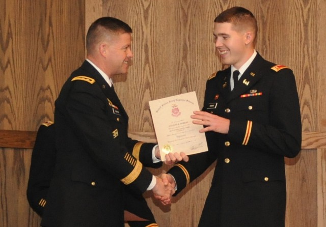 General presents son with Engineer Basic Officer Leadership Course certificate