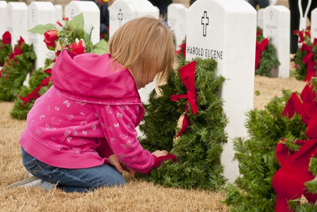 Christmas wreath placed with love on grave of fallen hero