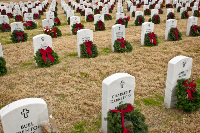 Christmas wreaths placed on grave markers of the fallen