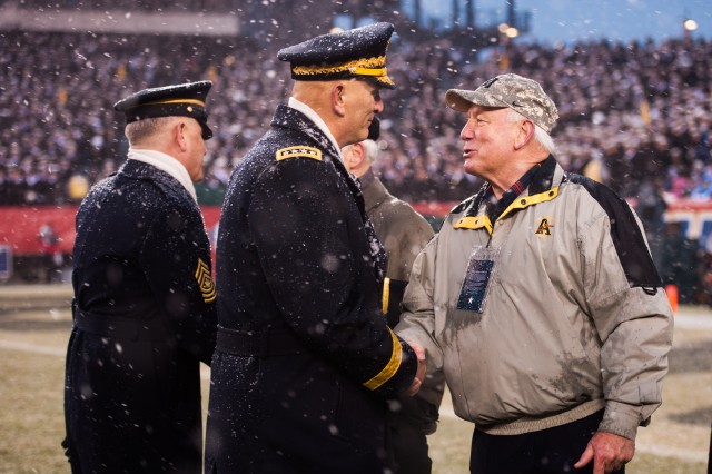 CBS football analysts Randy Cross (left) and Adam Zucker (middle