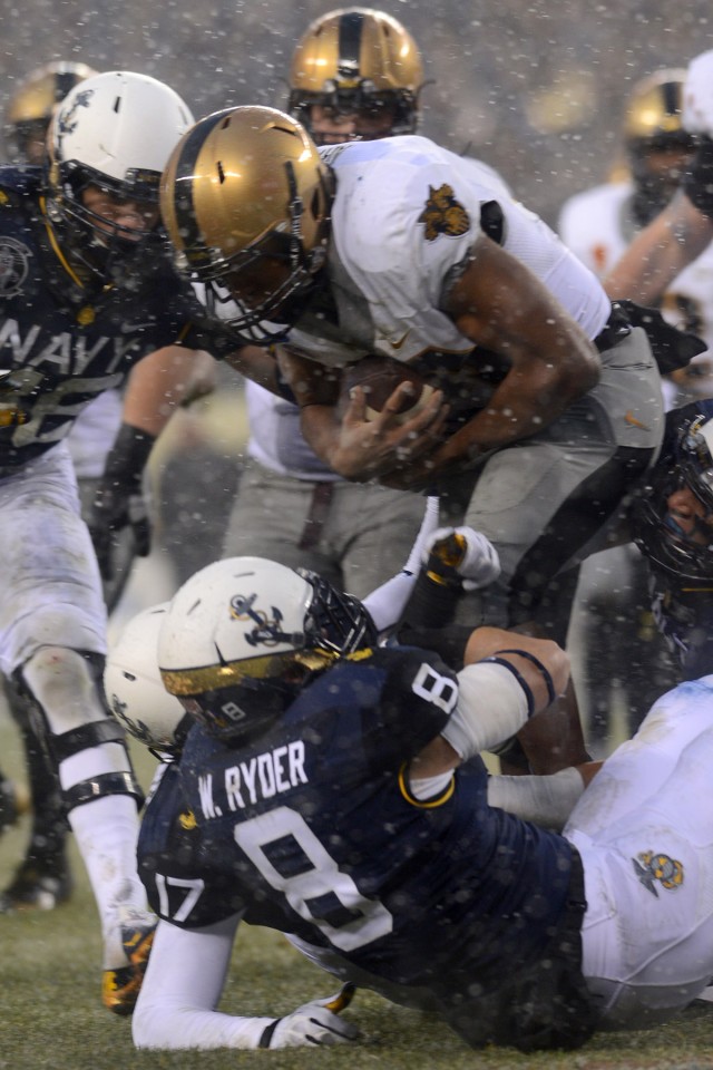 Navy drives past Army, 34-7, In snow-covered showdown