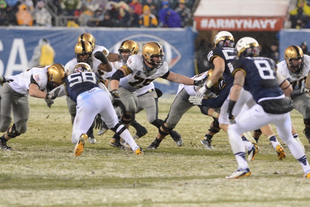 Navy drives past Army, 34-7, In snow-covered showdown