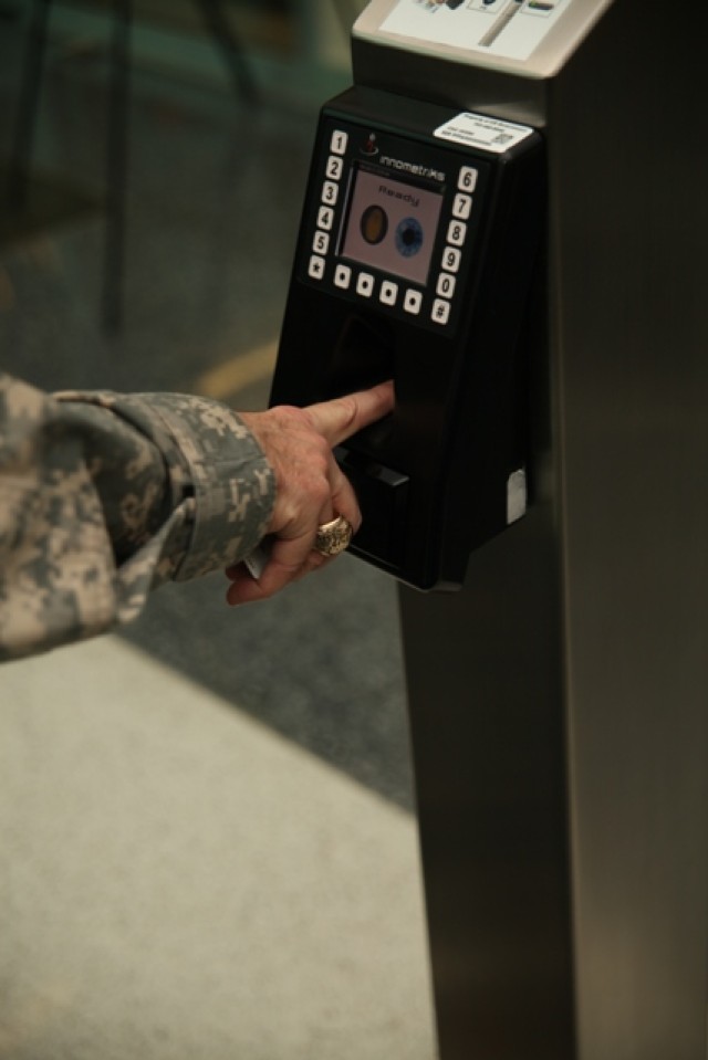 MG David Quantock places his right index finger in a fingerprint reader to gain access to the Mark Center's VIP entrance